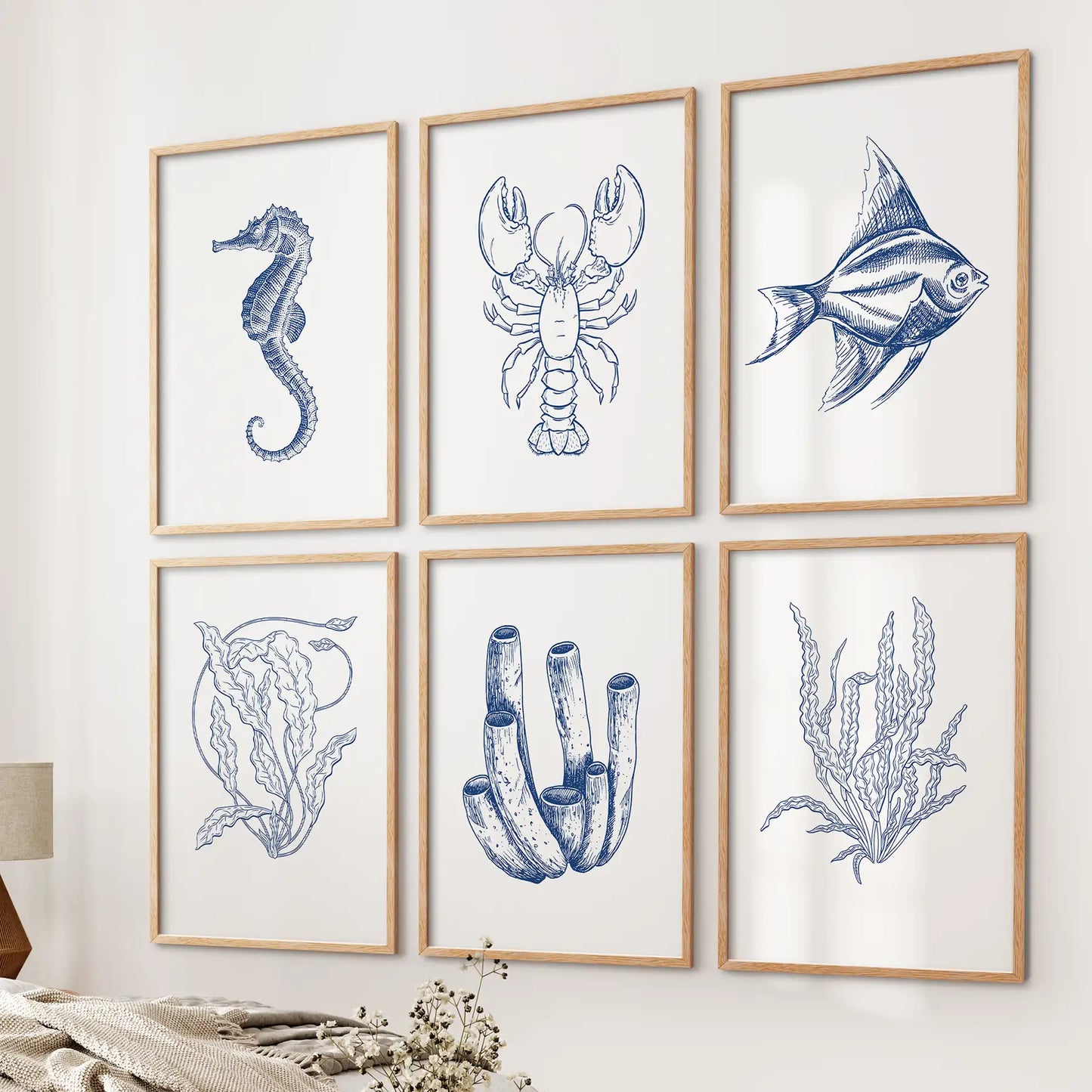 Neutral seaweeds prints set of 6. Lobster, fish, seahorse trendy room decor. Thinwood frames over the bed.