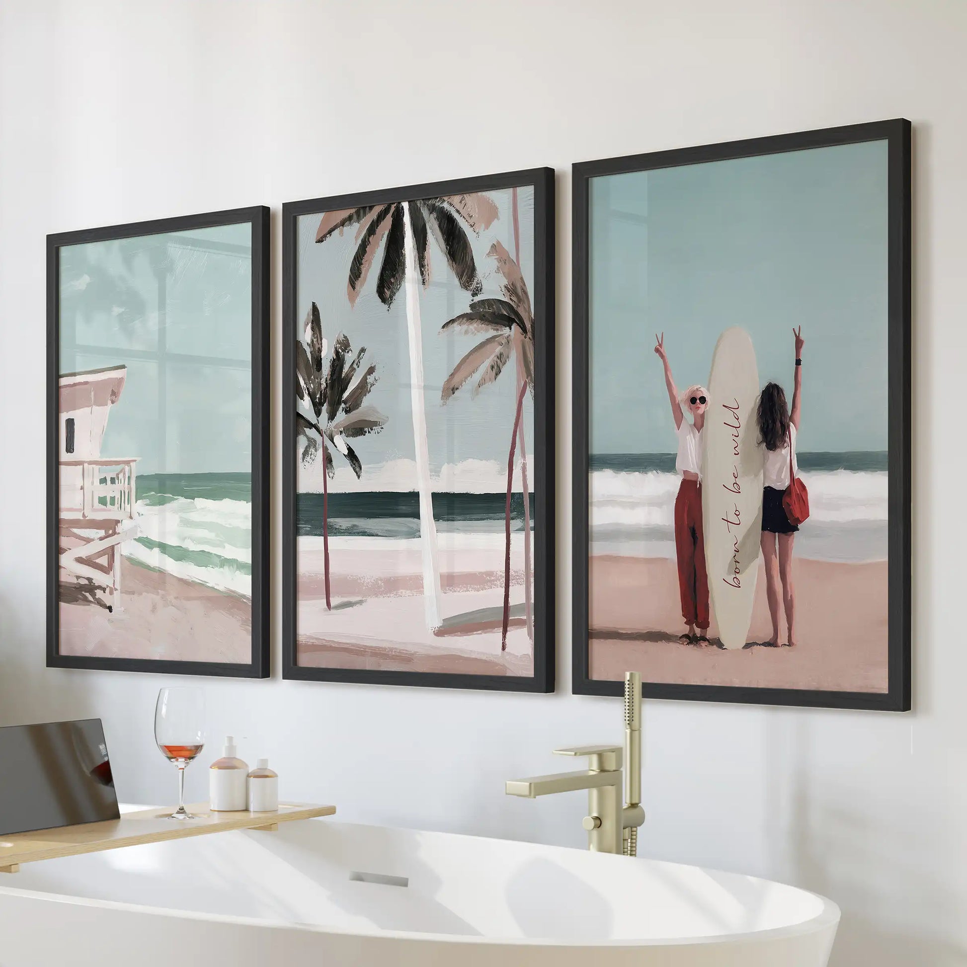 A black-framed 3-piece wall art set of ocean waves and shoreline hangs above the bath, bringing a calm California coastal touch to the bathroom.