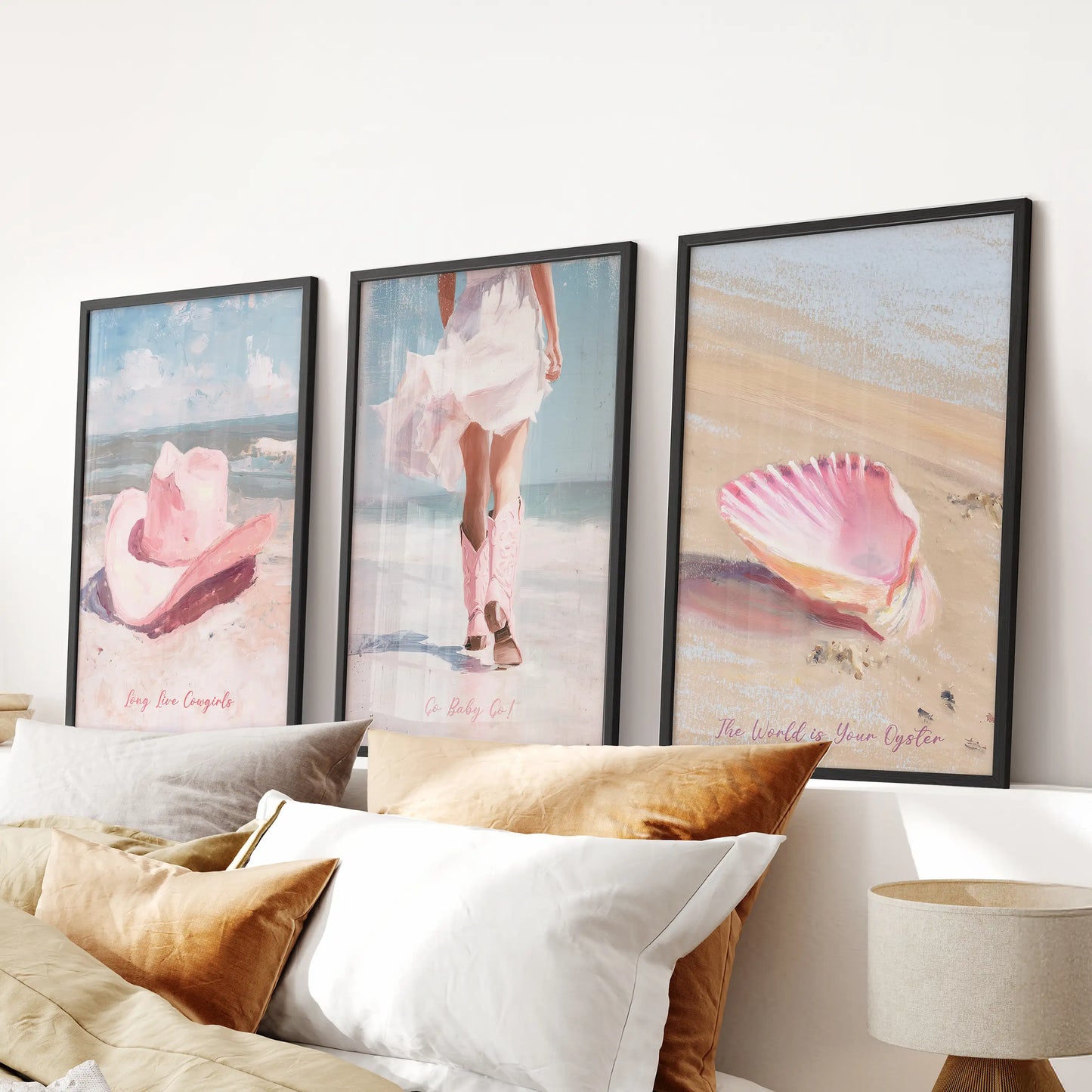 Vintage pink beach scene 3-piece wall art, hung above the bedroom headboard in black frames, lending soft coastal glow with a hint of western whimsy.