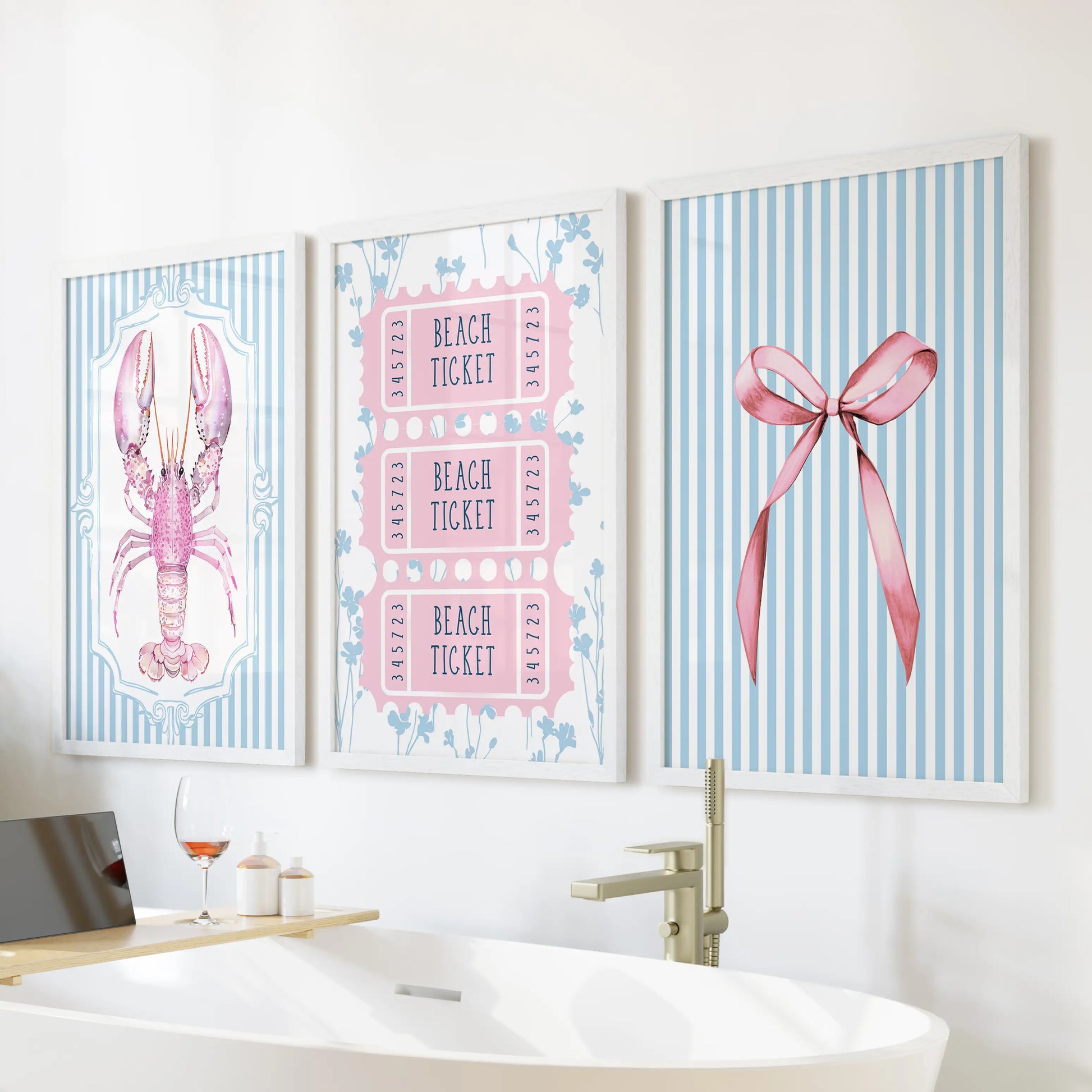 Three white-framed seaside prints of shells and starfish rest above the tub, adding breezy summertime calm to the bright bathroom.