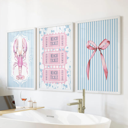 Three white-framed seaside prints of shells and starfish rest above the tub, adding breezy summertime calm to the bright bathroom.
