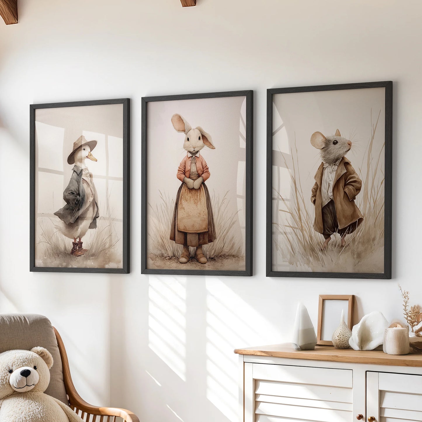 Mouse and rabbit farm animal wall art, a trio set in black frames for a kids room, arranged over the chest of drawers in a soft neutral palette.