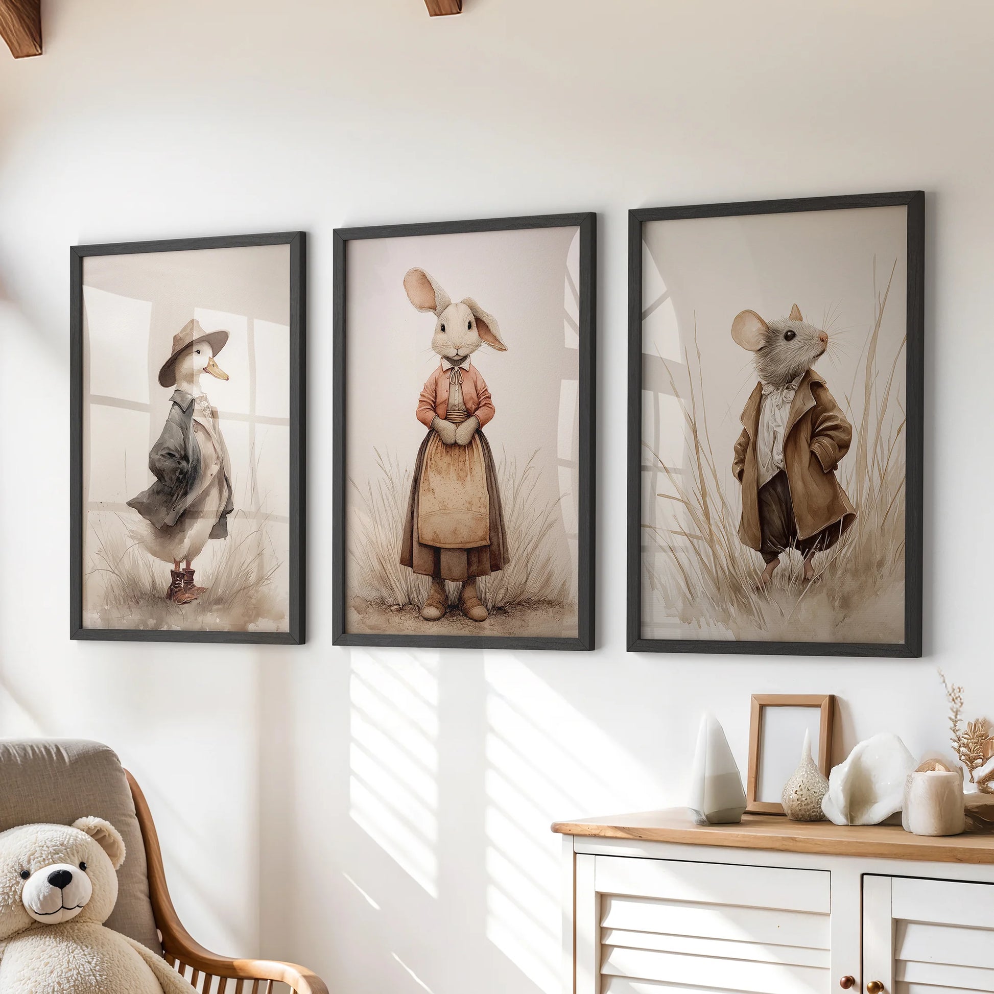 Mouse and rabbit farm animal wall art, a trio set in black frames for a kids room, arranged over the chest of drawers in a soft neutral palette.