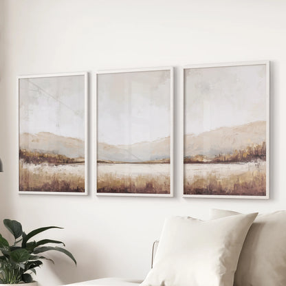 A 3-piece gallery wall of beige vintage landscape prints in white frames anchors the sitting room over the sectional with soft warmth.