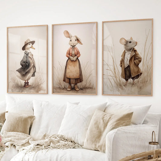 Cottagecore nursery wall decor duck and mouse art prints with cozy, old fashioned outfits. Thinwood frames over the couch.