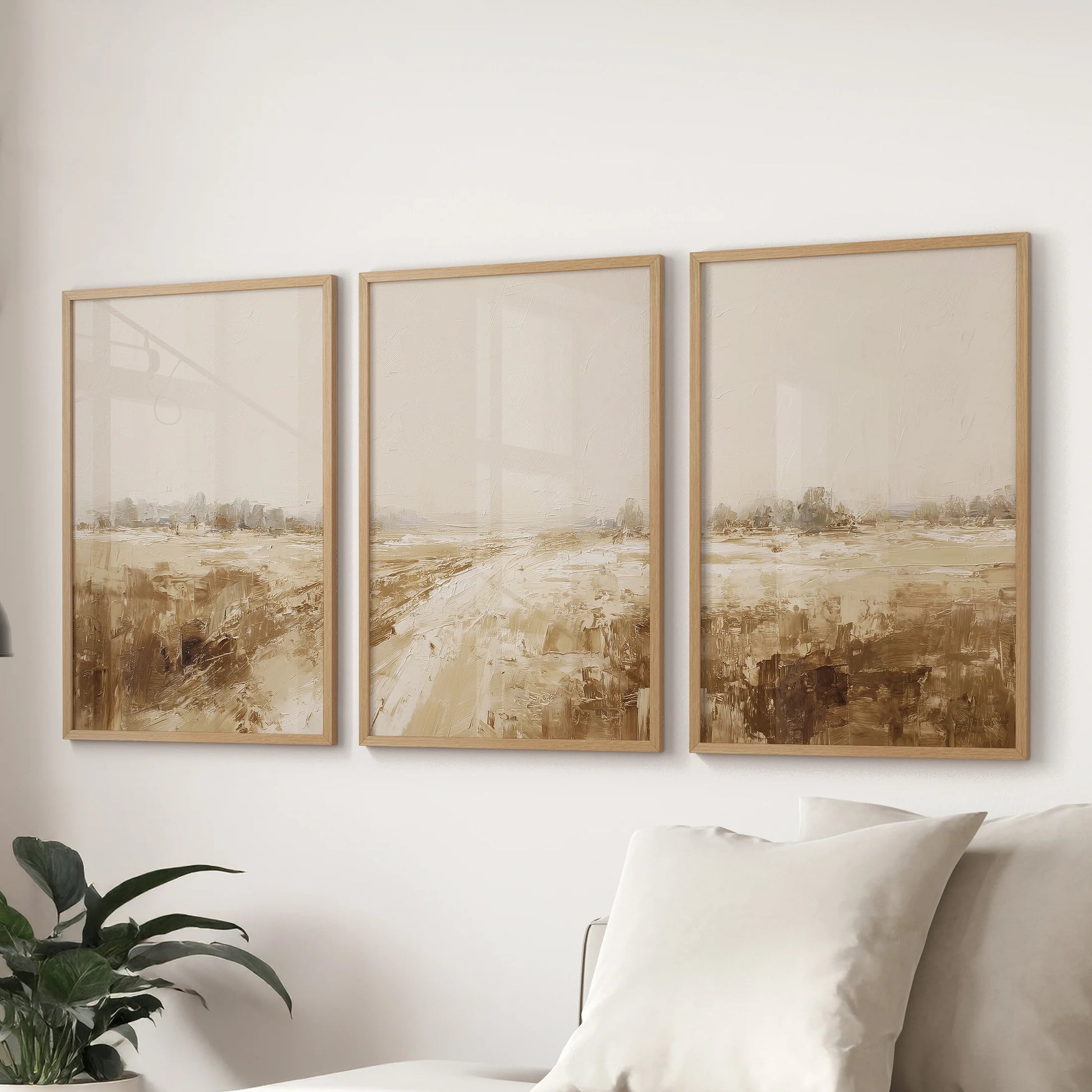 Earth-tone abstract horizon artwork, a 3-print set in oak frames, balances the lounge space beautifully above the sofa.