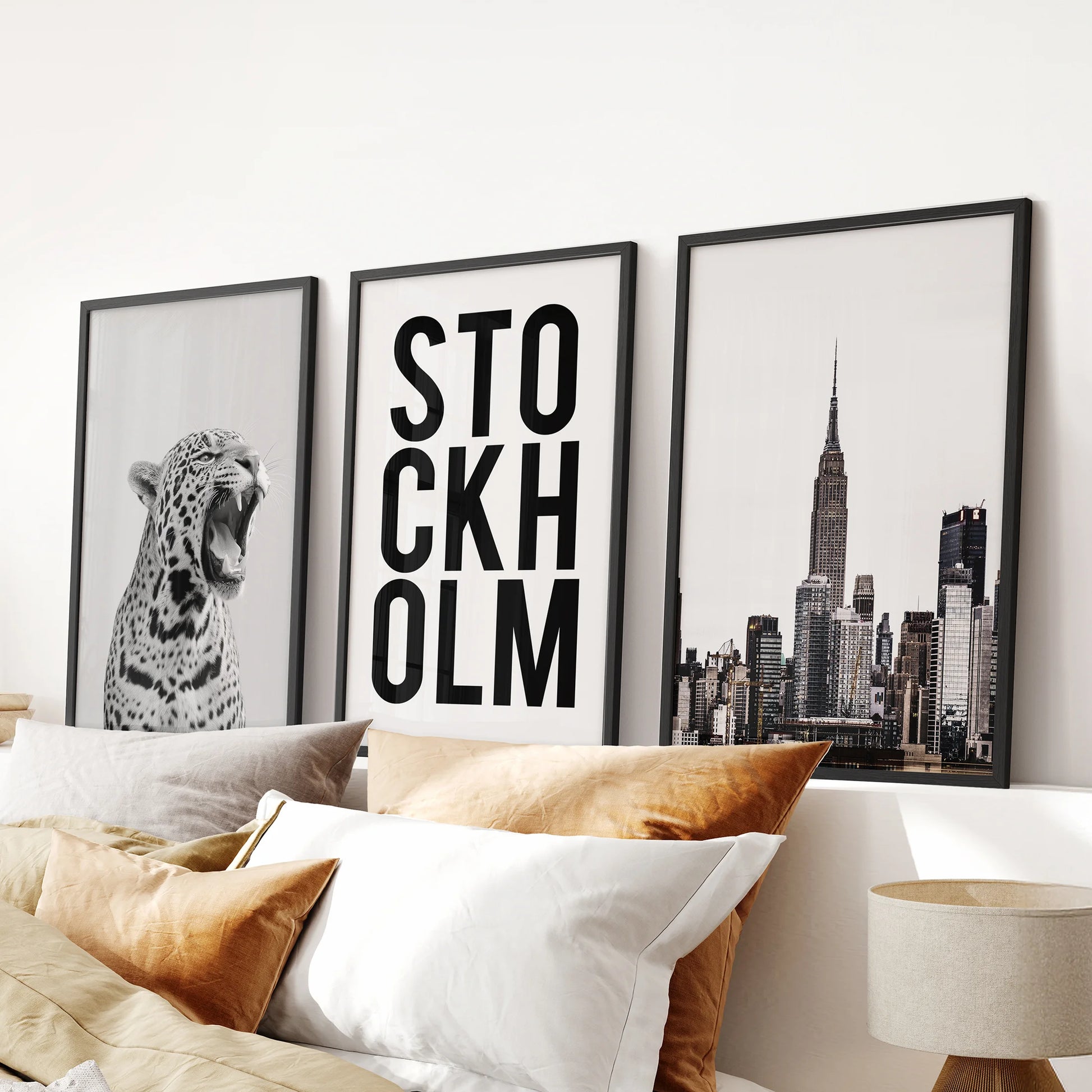 Black-and-white leopard print wall art, three-print set in black frames, styled over the headboard to sharpen a modern bedroom.