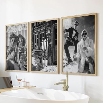 Bar cart pint glasses, a 3-piece art print set in thin wood frames, hang above the bathtub and add a clean, graphic touch to the bathroom.