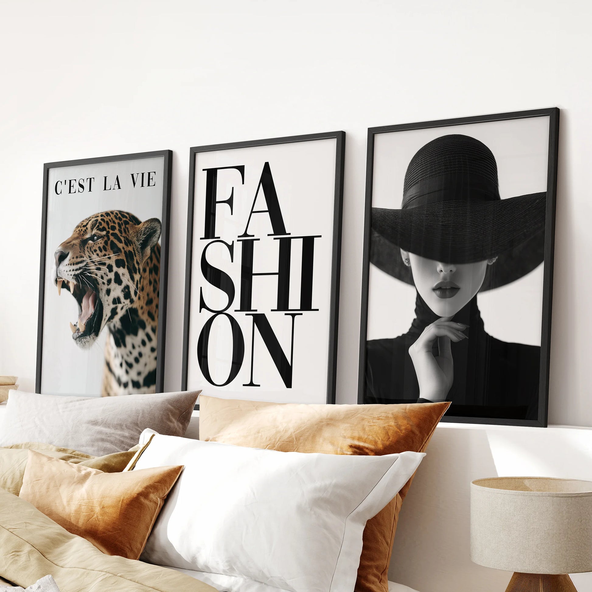 Black-and-white leopard print fashion wall art set of three in sleek black frames, styled over the bed to anchor a modern bedroom.
