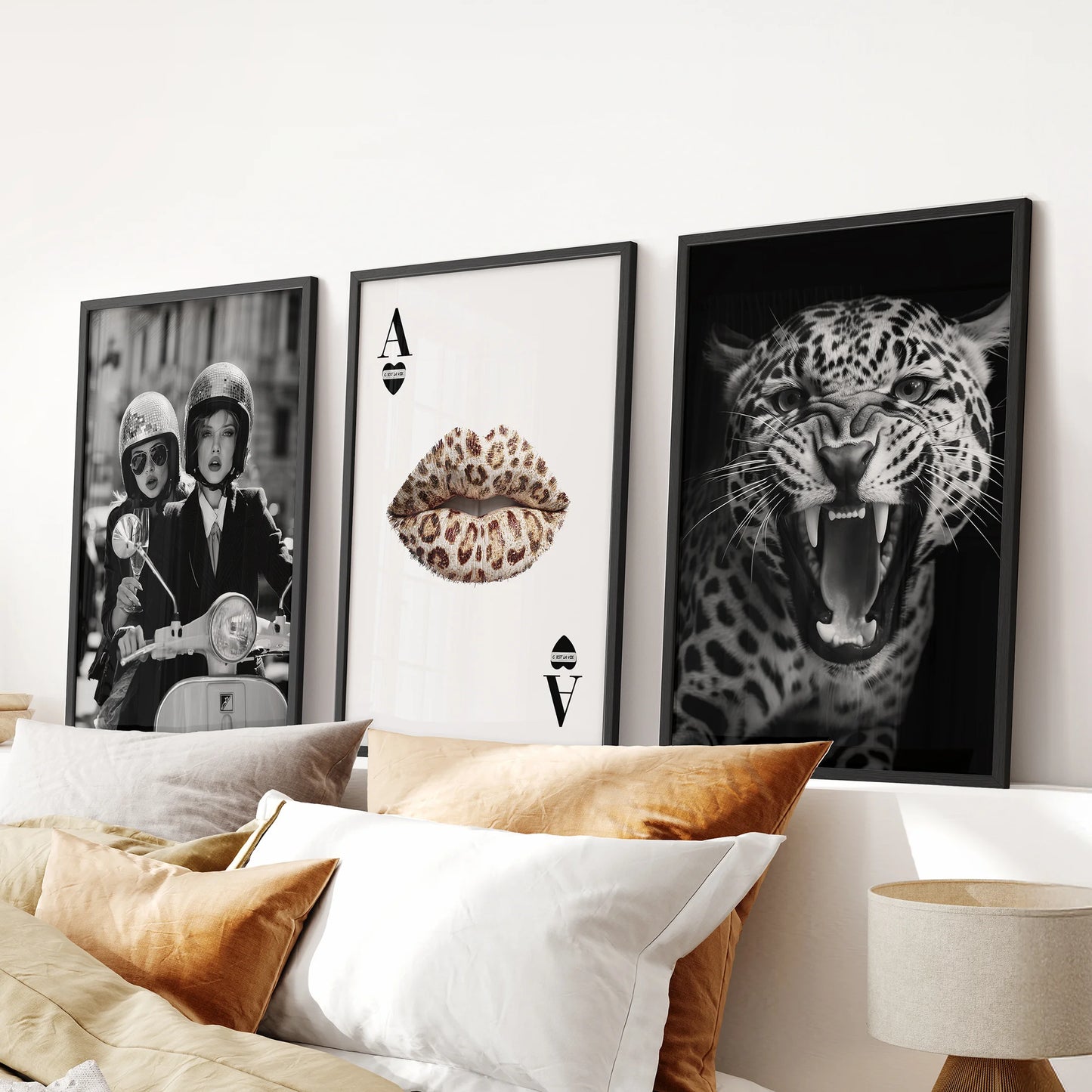 Set of three black-and-white wall prints in sleek black frames, styled above the bed's headboard to elevate a modern bedroom look.
