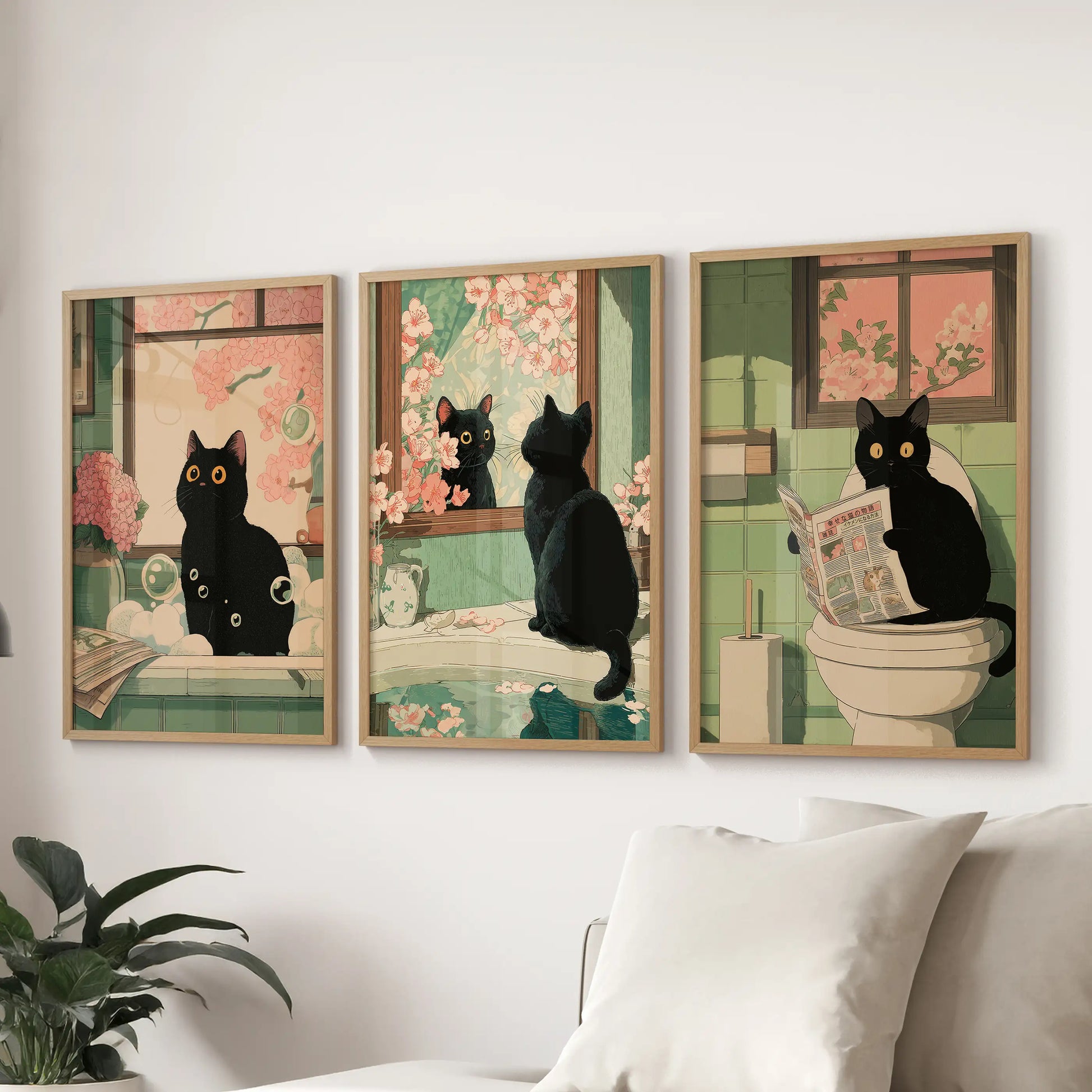 Japanese-style cat on a toilet, a gallery of three prints in natural oak frames, completes lounge wall art arranged neatly behind the couch.