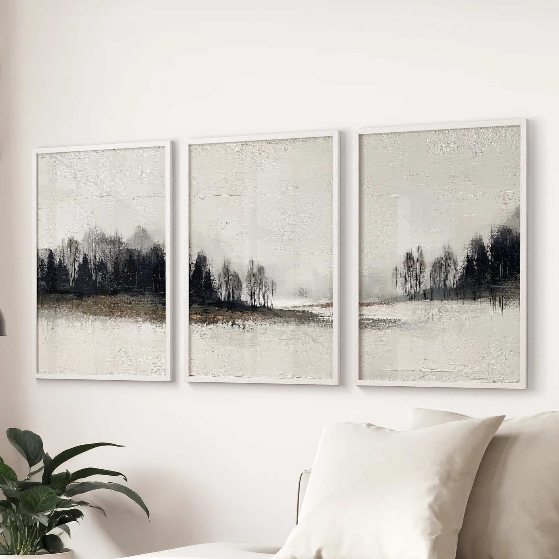 Black, white, and beige nature prints, a 3-piece poster set in white framed borders, span the family room wall above the sectional.