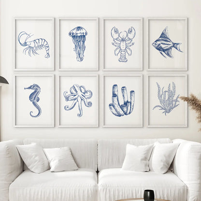 Nautical sea life art set shrimp, seahorse, angelfish, and more in a blue and white coastal themed gallery wall. White frames above the sofa.