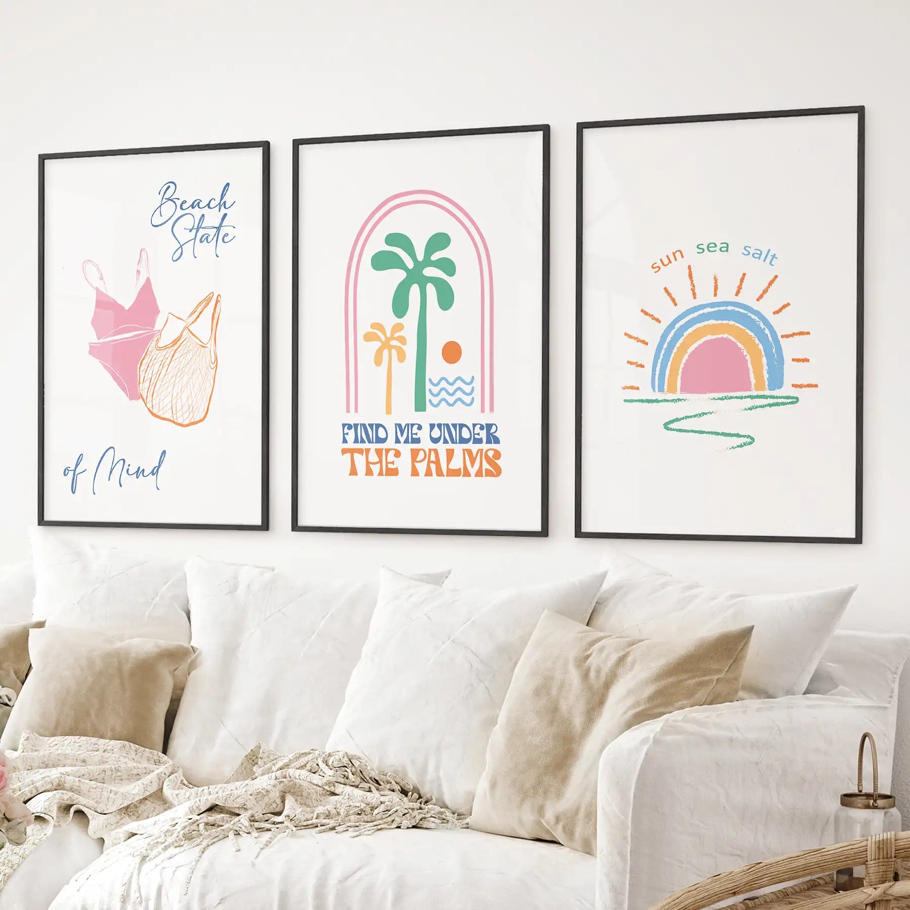 Colorful coastal wall prints with palm, rainbow sunset, and summer vibes. Black frames above the sofa.