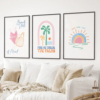 Colorful coastal wall prints with palm, rainbow sunset, and summer vibes. Black frames above the sofa.