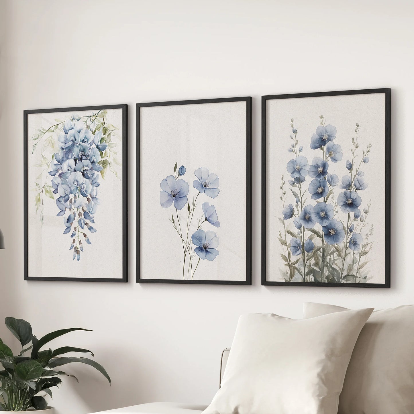 A trio of blue watercolor floral wall art prints in black frames hangs above the sectional sofa, freshening the lounge with crisp botanical detail.