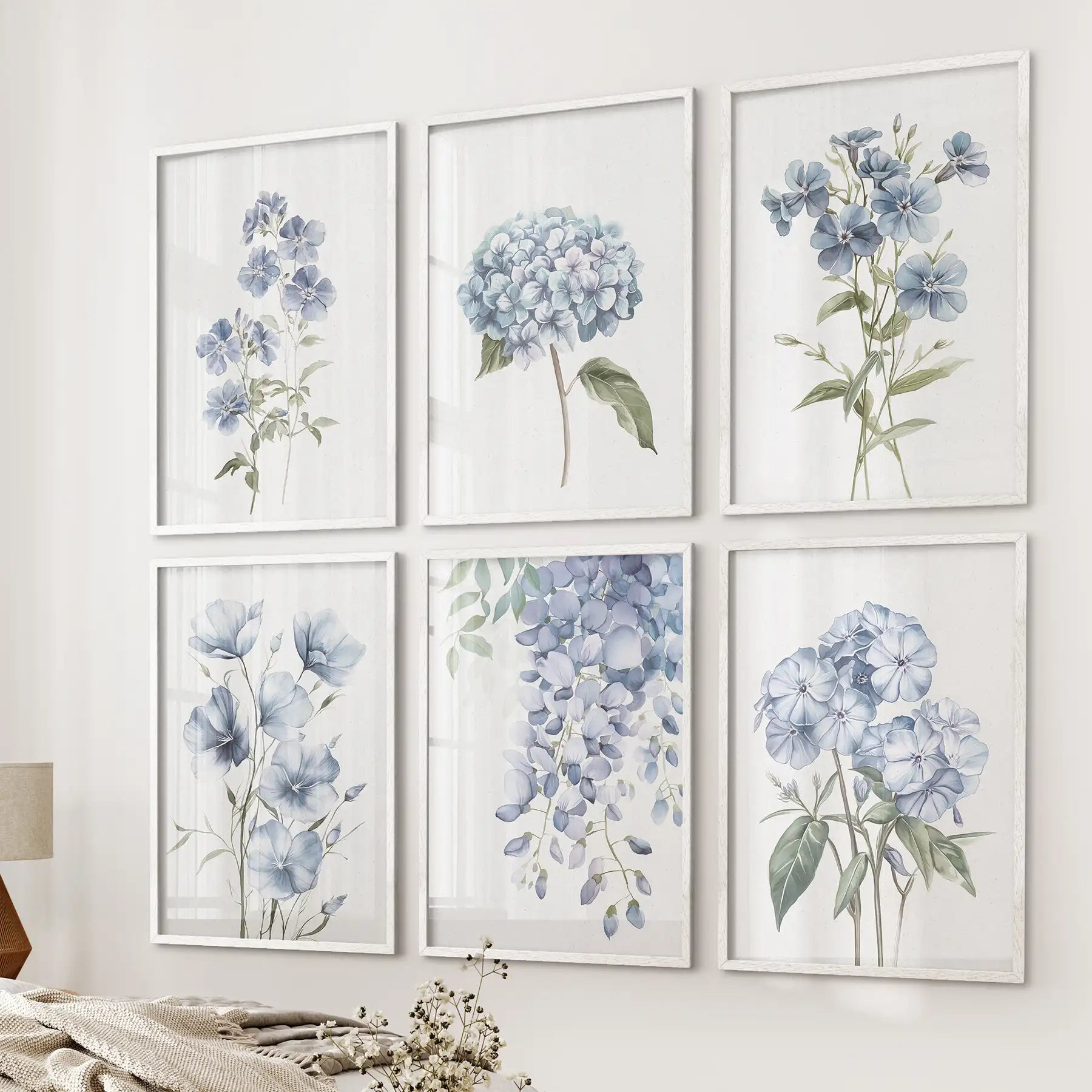 Gallery wall of soft blue botanical prints. Garden flowers summer wall decor. White frames for bedroom.