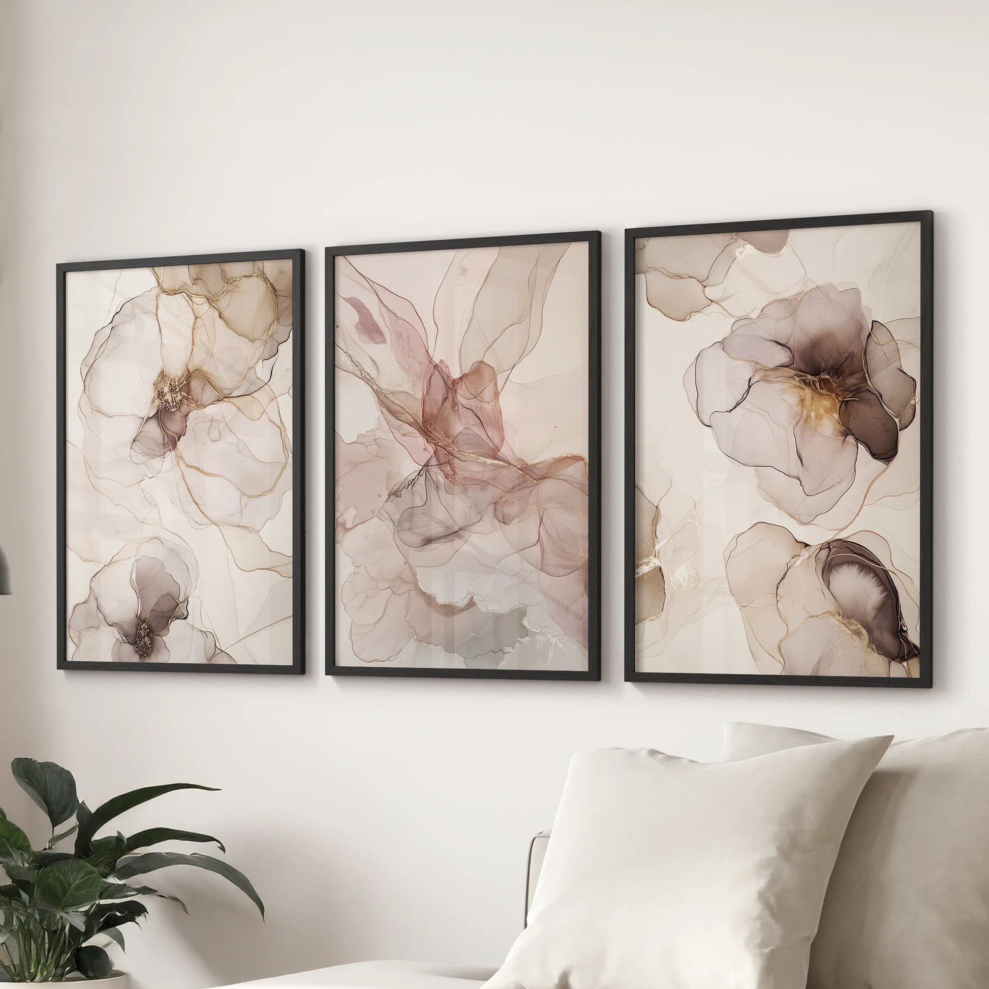 A wall art 3 set of neutral blush and beige tones in sleek black frames brings calm balance to the sitting room over the sofa.