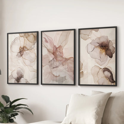 A wall art 3 set of neutral blush and beige tones in sleek black frames brings calm balance to the sitting room over the sofa.
