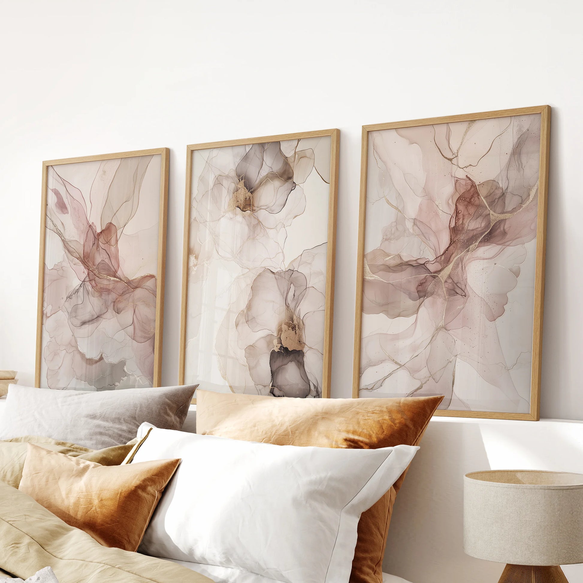 Blush watercolor floral abstract prints, three-print set, in natural wood frames to brighten a bedroom wall above the bed with gentle, airy color.
