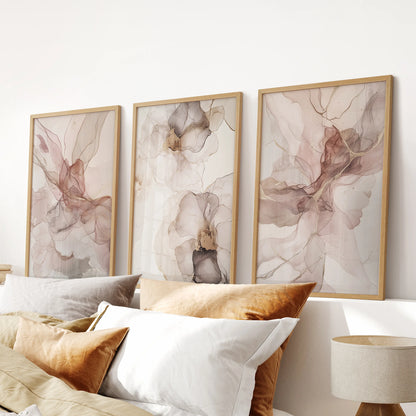 Blush watercolor floral abstract prints, three-print set, in natural wood frames to brighten a bedroom wall above the bed with gentle, airy color.