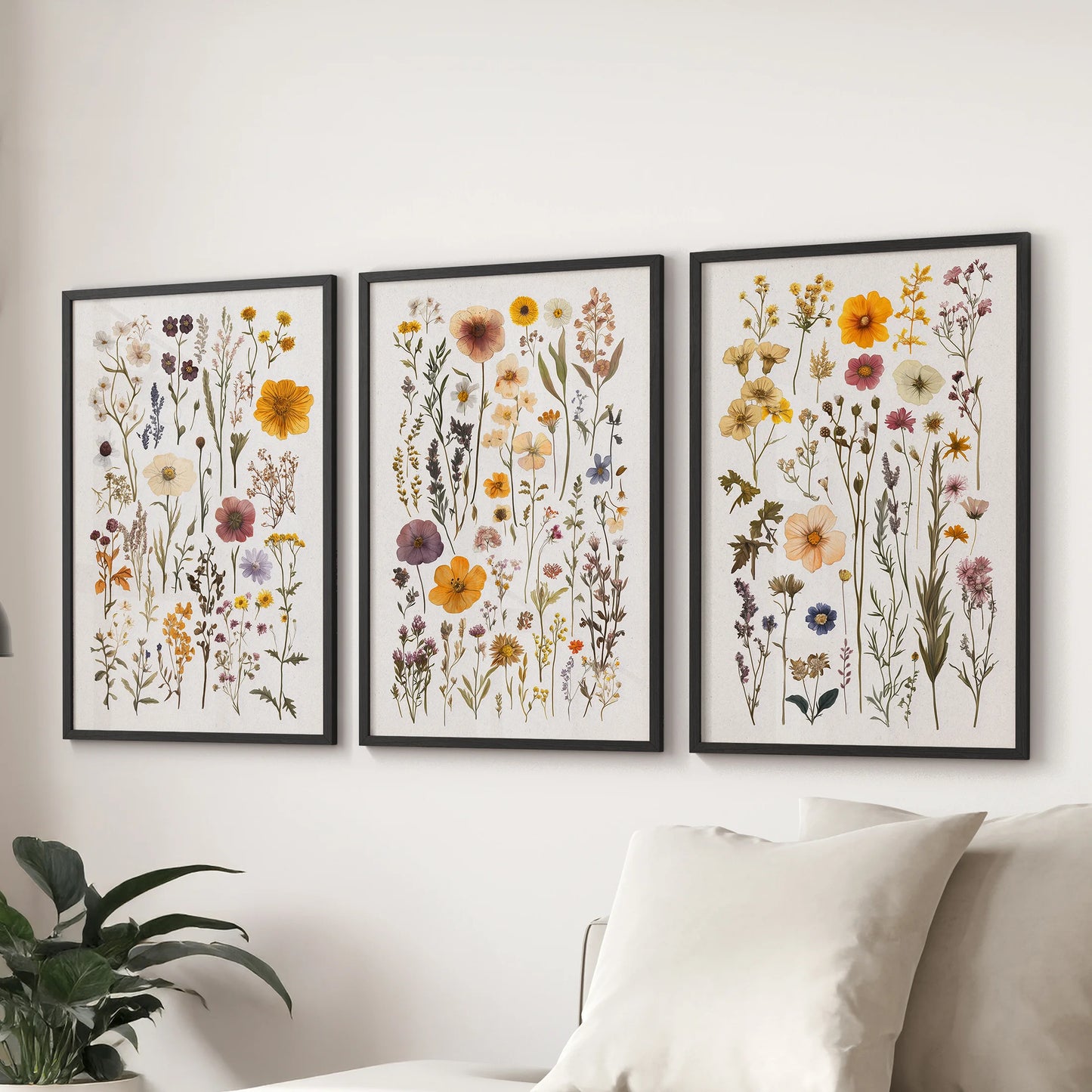 A 3-piece poster set of colorful garden flowers in black frames adds cheerful color behind the sofa in the lounge.