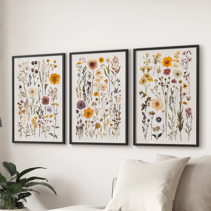 A 3-piece poster set of colorful garden flowers in black frames adds cheerful color behind the sofa in the lounge.