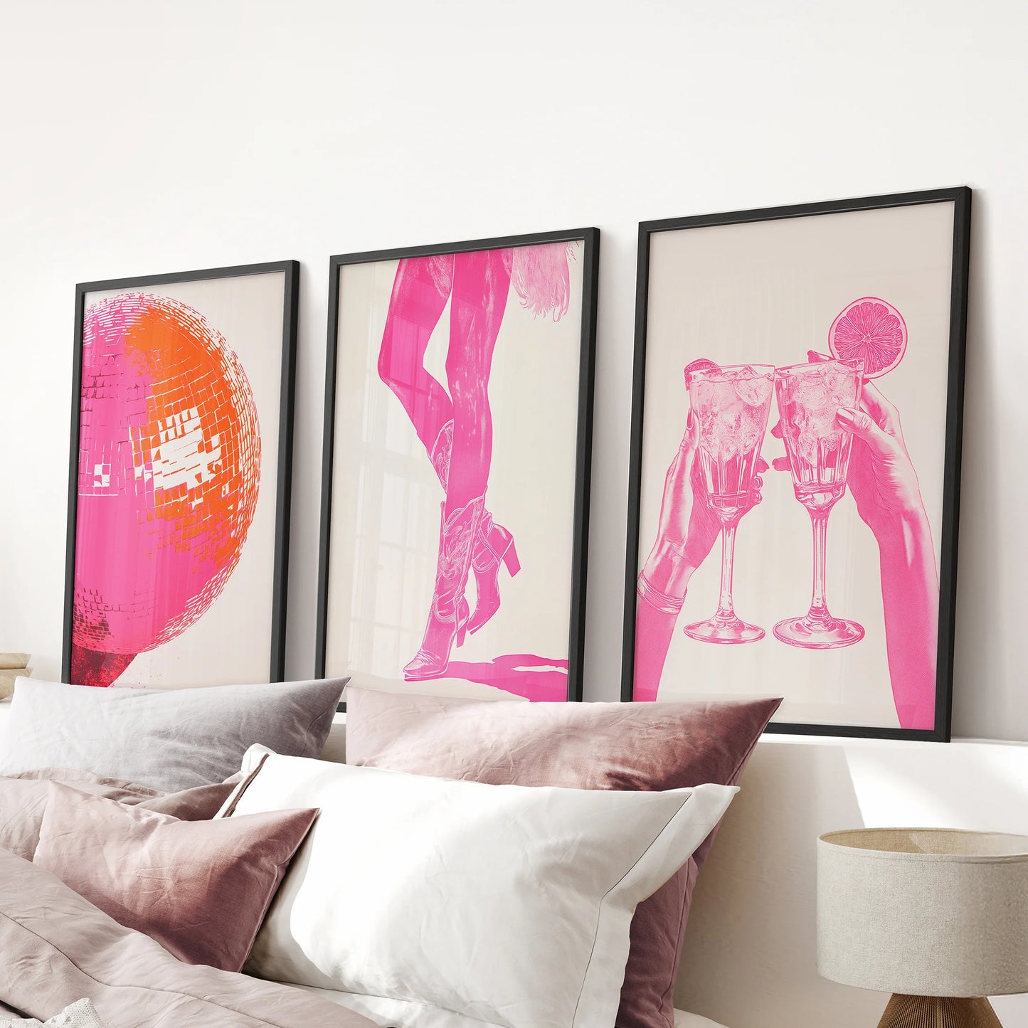 Hot pink abstract art prints, set of 3 pictures, are black framed and placed above the bed headboard, saturating a pink bedroom with bold color.