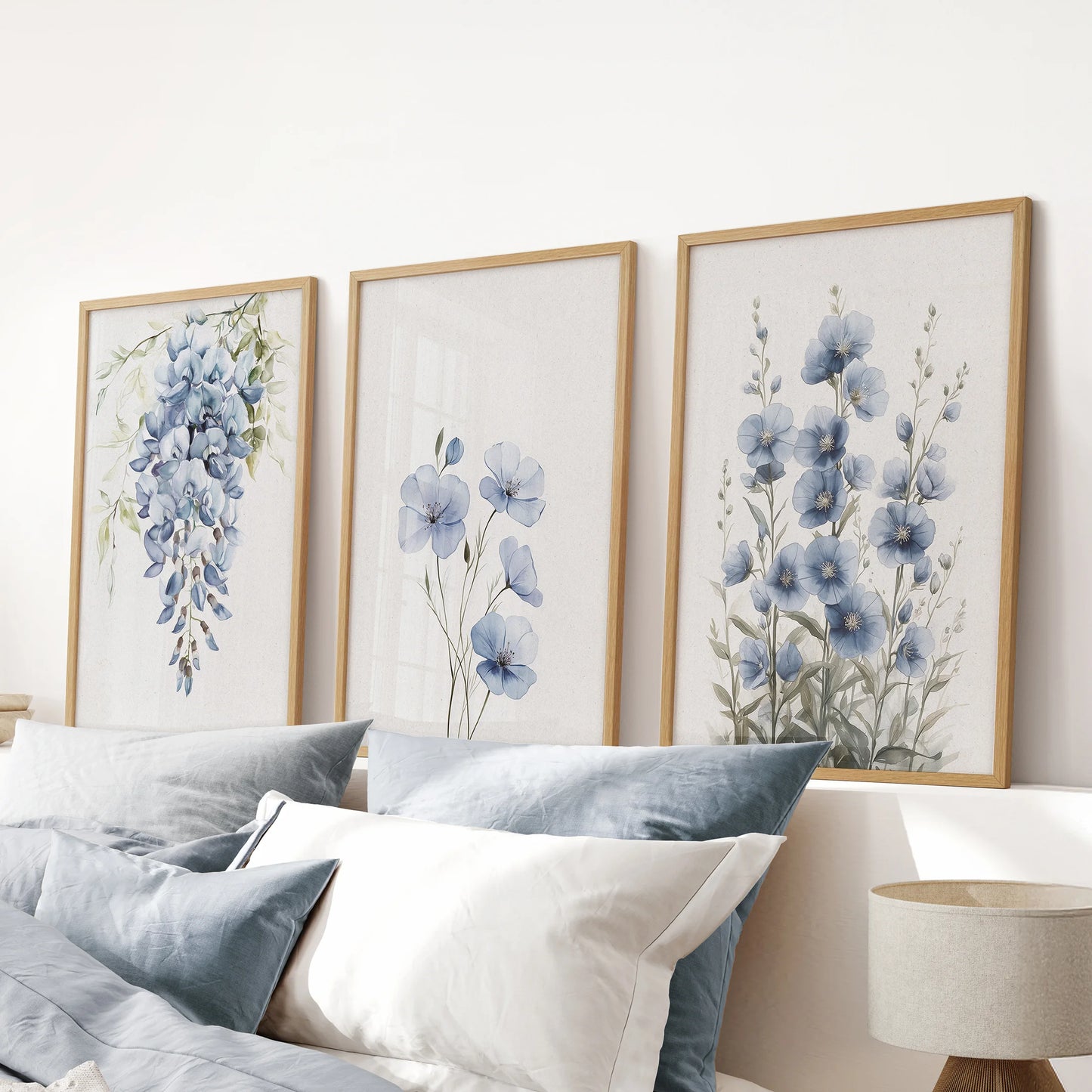 Chinoiserie blue blossoms in a set of three art prints sit within oak frames above the headboard, sharpening the pink bedroom with elegant botanicals.