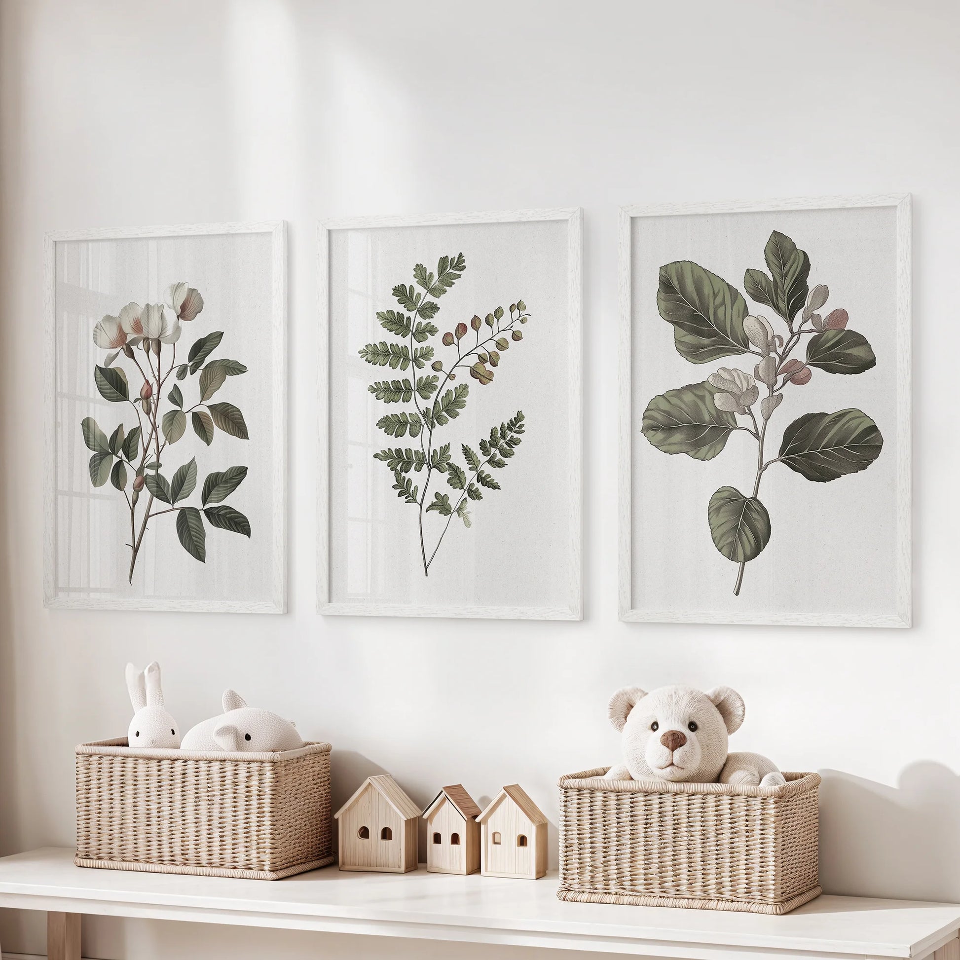 Neutral floral prints, a three-print set in crisp white frames, line the kids room wall over the toy organizer for a fresh, airy art accent.