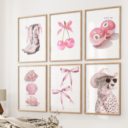Cowgirl boots and bow graphics in a six-print wall art set, natural wood framed, bring playful Western flair to the bedside wall of a cozy bedroom.