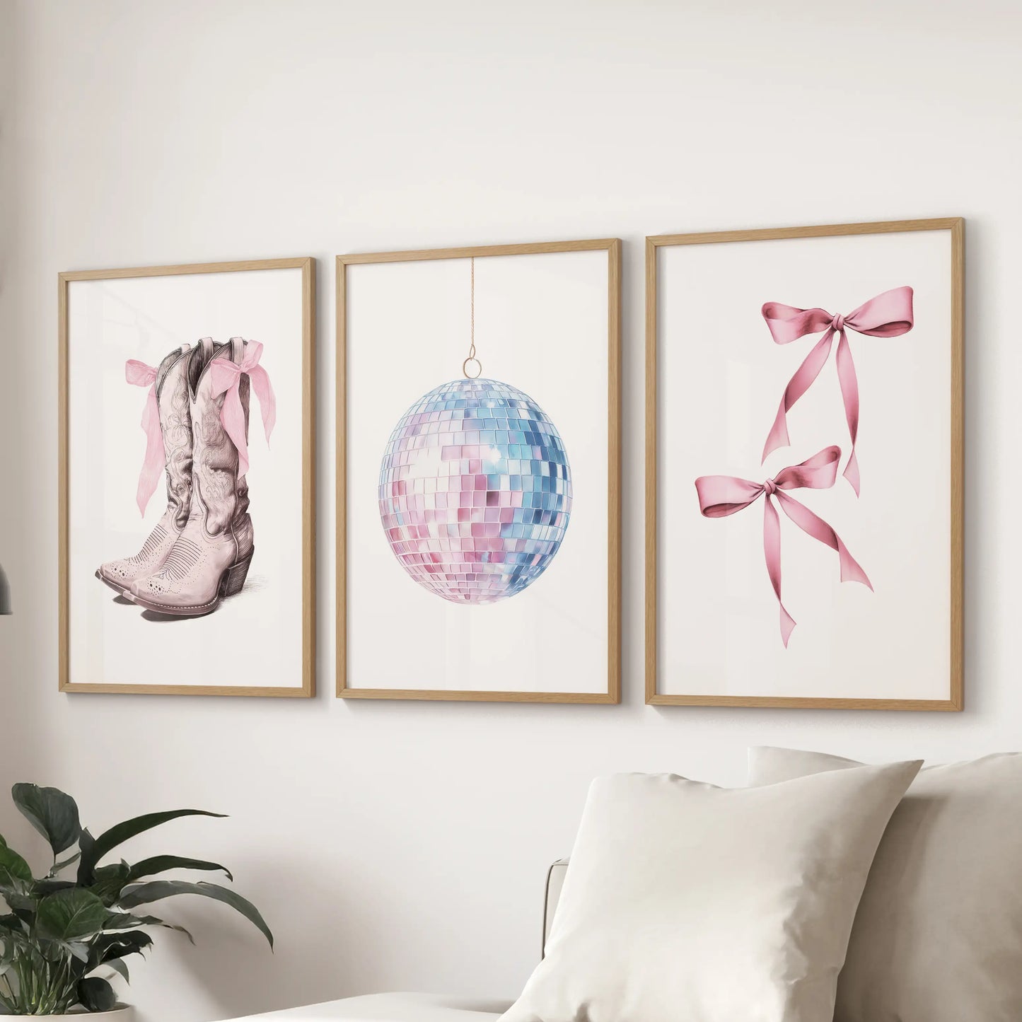 Coquette bow art print trio, set in solid oak frames, floats over the sectional to warm the family room with a soft, girly coastal note.