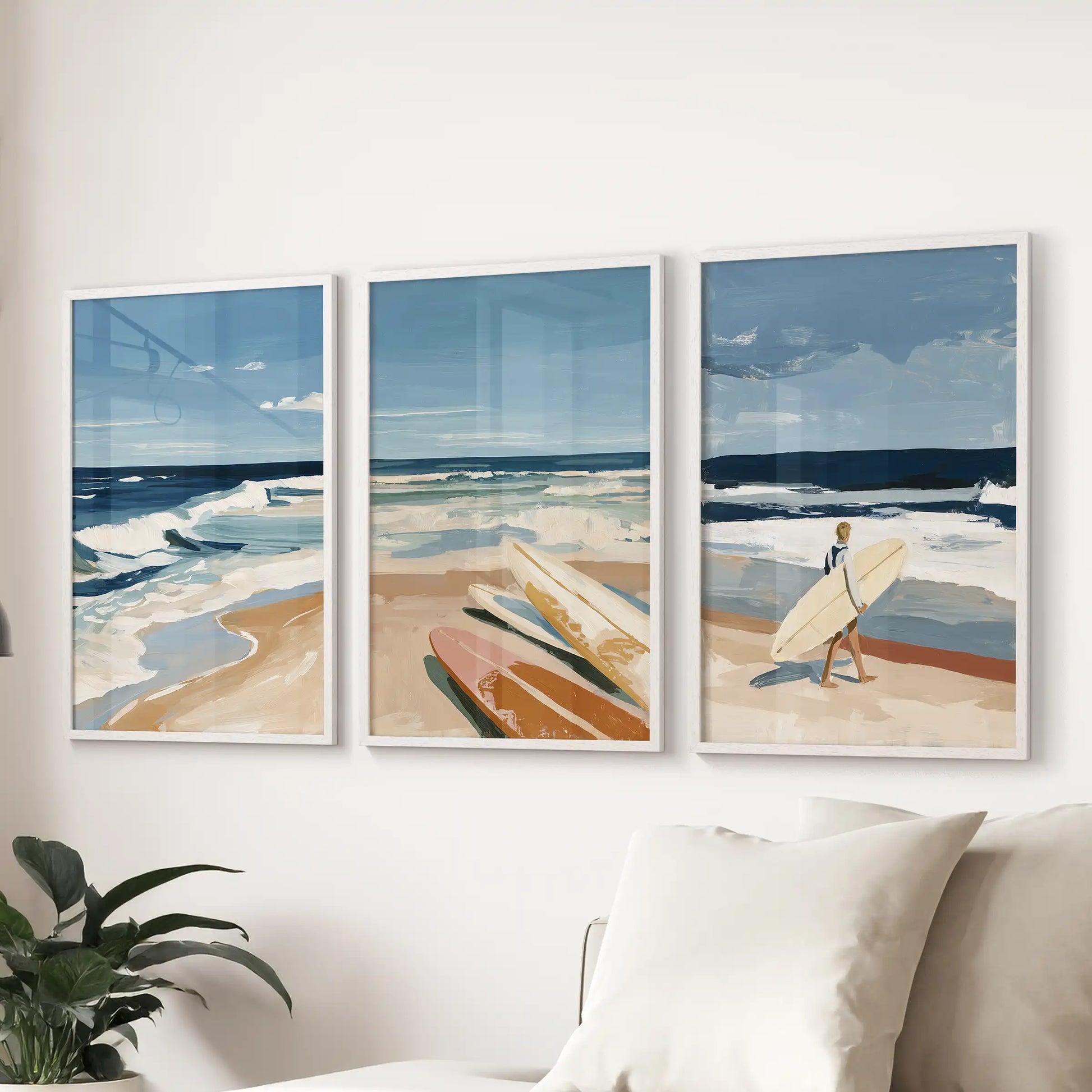Beach shoreline scenes wall art, a white-framed triptych, lines the sitting room wall behind the couch for an easy, salt-air focal row.