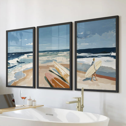 California beach culture wall art set of three brings airy coastal vibes, with black-framed prints styled in a bathroom over the bathtub.