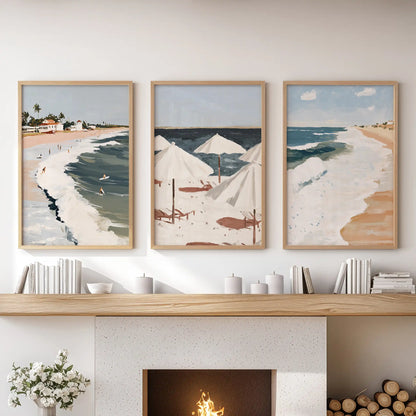 Three natural-wood-framed ocean wave prints stretch across the sitting room mantel, setting a relaxed coastal focal point for the space.