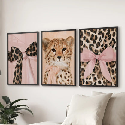 Leopard and cheetah wall set, three framed prints in black, mounted above the sectional sofa to form a tidy gallery row across the family room.