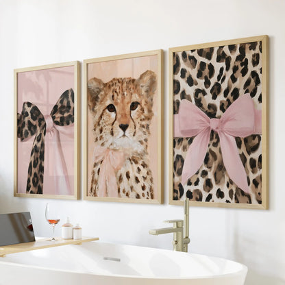 Pink-bow leopard wall art comes as a set of three in warm oak frames, arranged over the bath for a cozy, fashion-forward bathroom vignette.