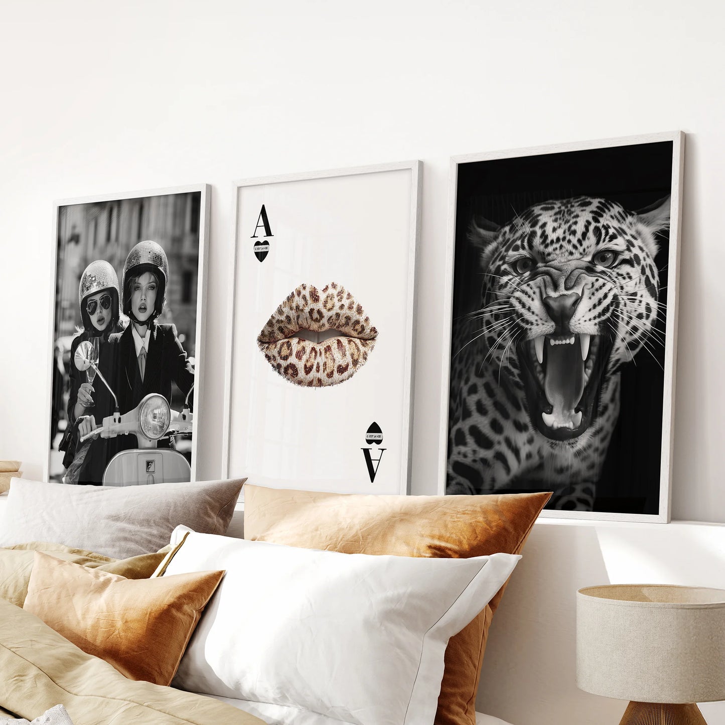 Cheetah print art, a three-print set in white frames, mounted over the headboard in a calm, modern bedroom retreat.