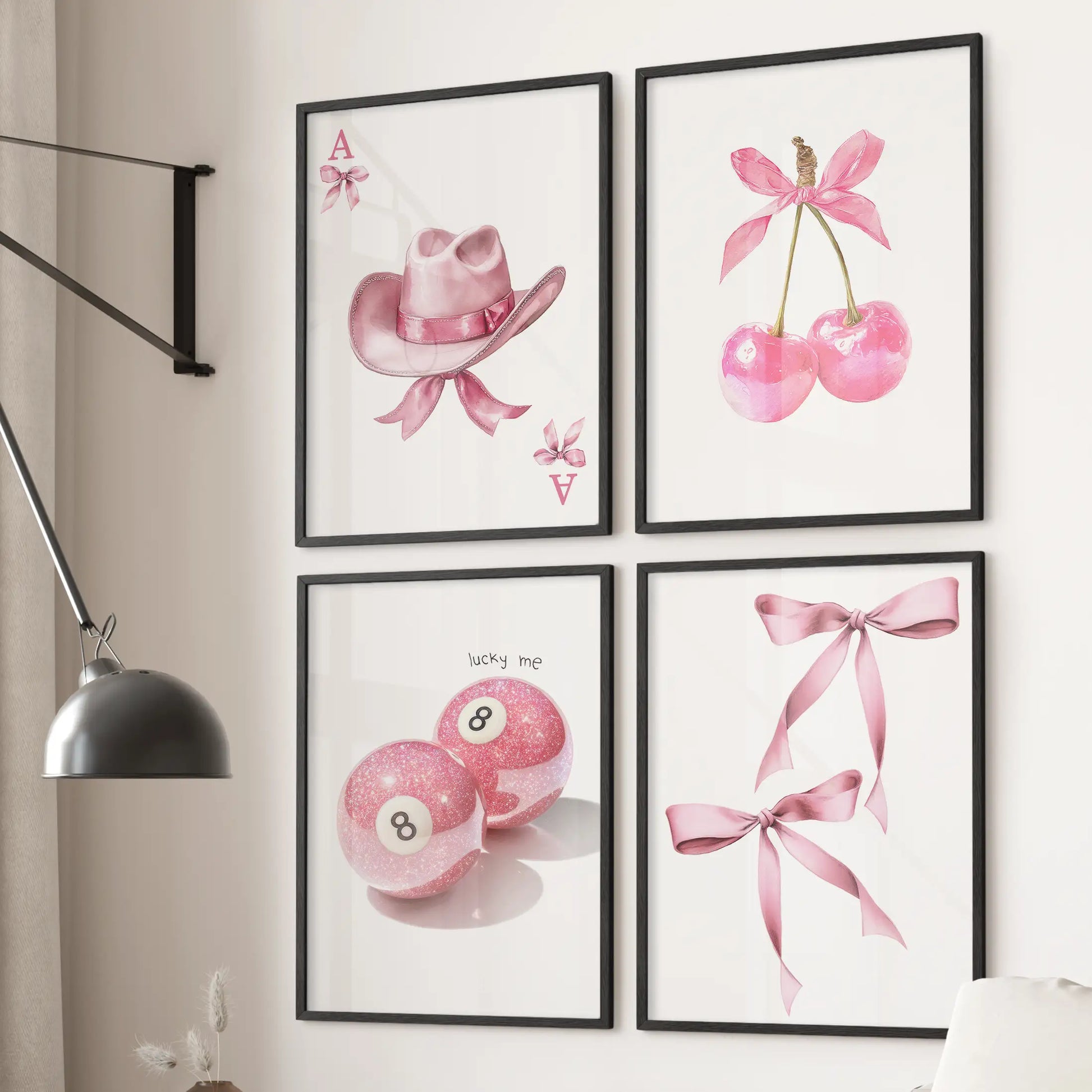 Cherries and ribbon bows wall art, set of four, in black frames styled over the sectional in a bright living room with a playful preppy pink vibe.