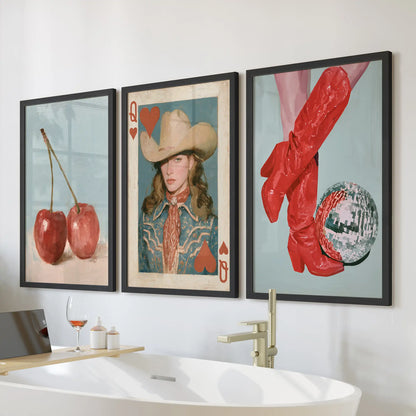 Cherries three-print wall art set in black frames hangs over the bath, lending a playful pop of red to the bathroom's clean lines.