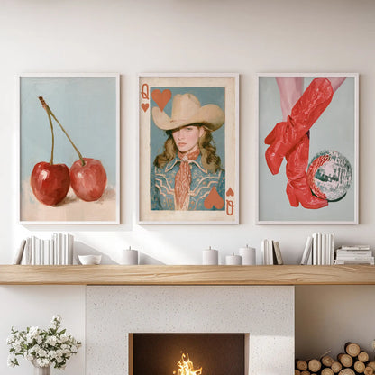 Playing card artwork, arranged as a set of three in white frames, sits over the hearth and gives the living room wall a cheeky graphic note.