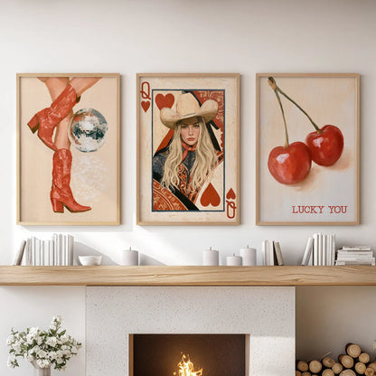 Red cowgirl boots wall art, a set of three prints in solid oak frames, spans above a sectional sofa and brings warm Western glam to the living room.