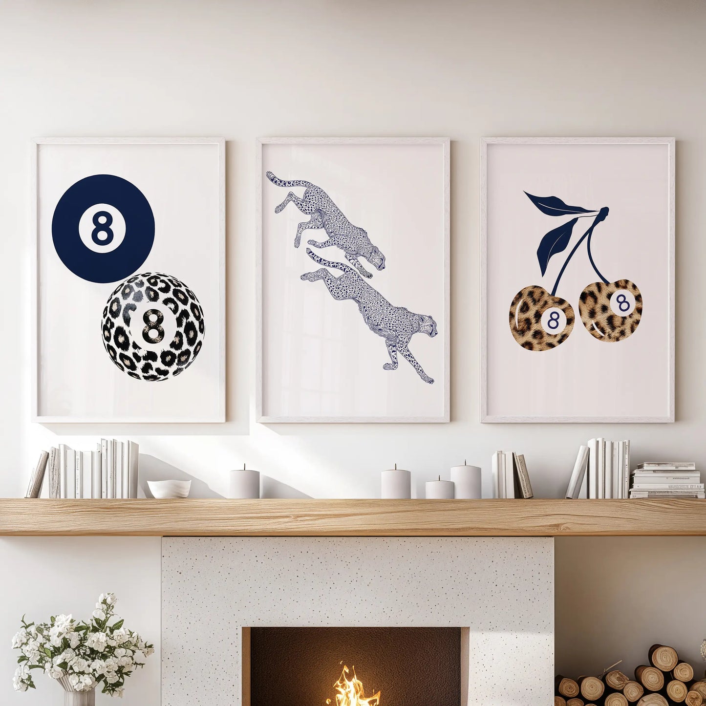 Three white-framed prints with retro pool-ball cherries add a playful pop as wall decor above the living room mantle.