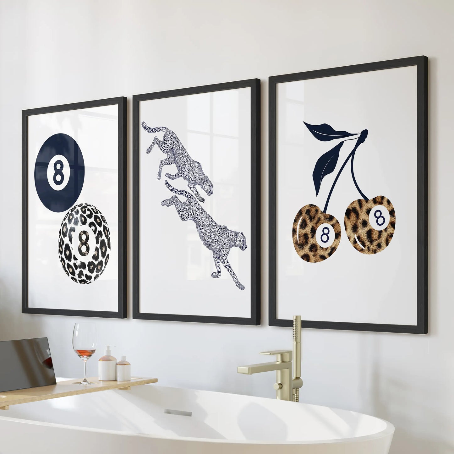 Cherry and eight-ball posters, a set of three wall art in sleek black frames, bring playful Y2K pop to the bathroom above the bathtub wall.