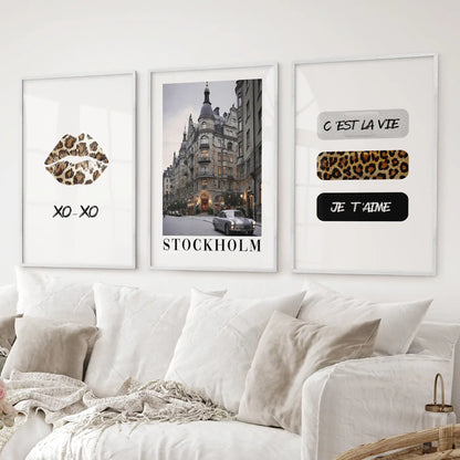 Stylish Stockholm city wall art with leopard print and quotes for gallery wall. College girl dorm lips poster. White frames above the sofa.