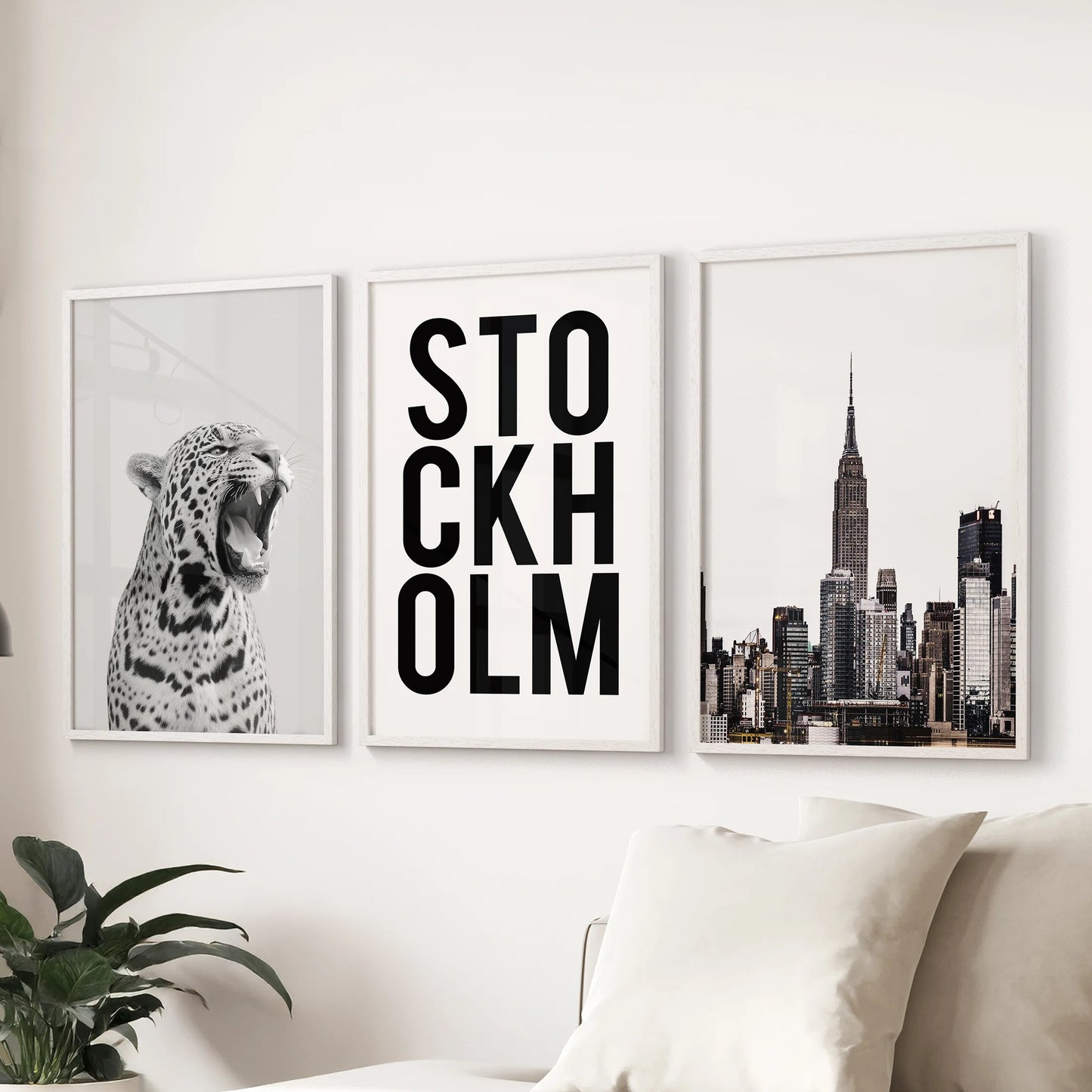 Stockholm-style monochrome wall art, a trio of prints in white frames, set behind the lounge sofa for a clean, design-forward statement.
