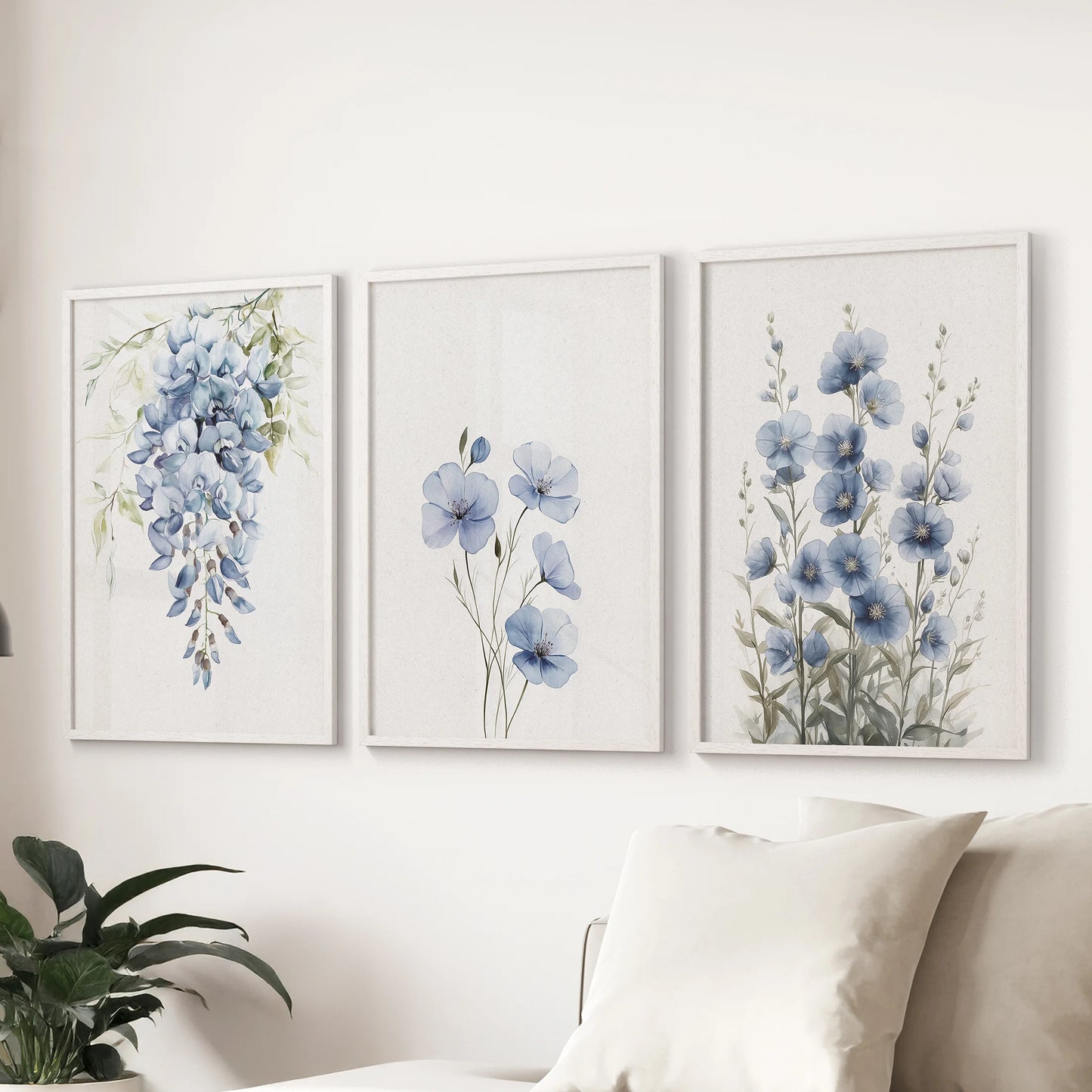 Modern blue floral wall art, a three-piece set in white frames, displays over the couch to lend the family room a calm, contemporary botanical feel.
