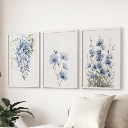 Modern blue floral wall art, a three-piece set in white frames, displays over the couch to lend the family room a calm, contemporary botanical feel.