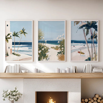 Lounge wall art of three white-framed shoreline prints layers pale horizon color above the mantelpiece for a serene central accent.