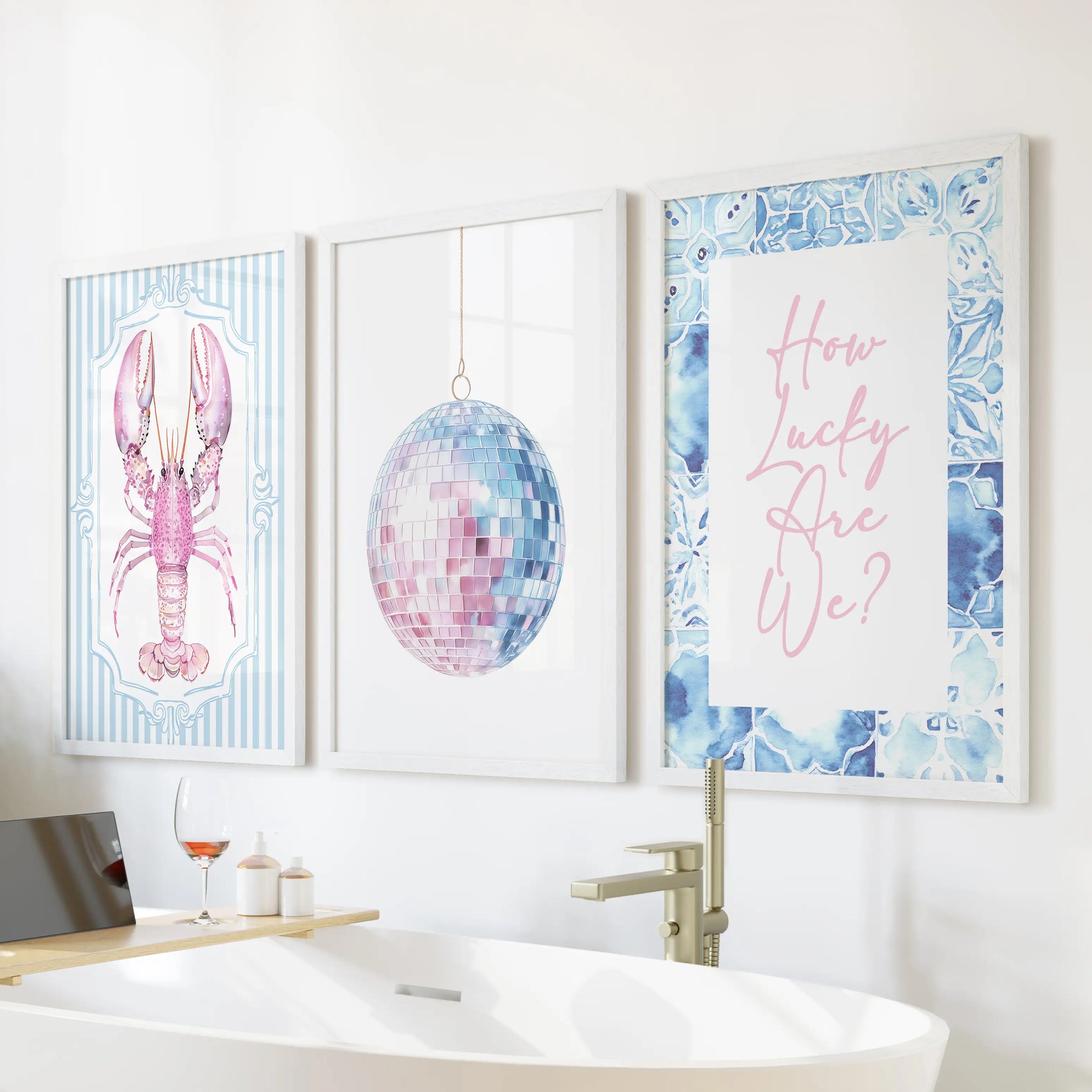 Coastal pastel beach art three-piece set in white frames hangs over the bathtub, blending soft blue-and-pink tones for a serene, feminine spa feel.